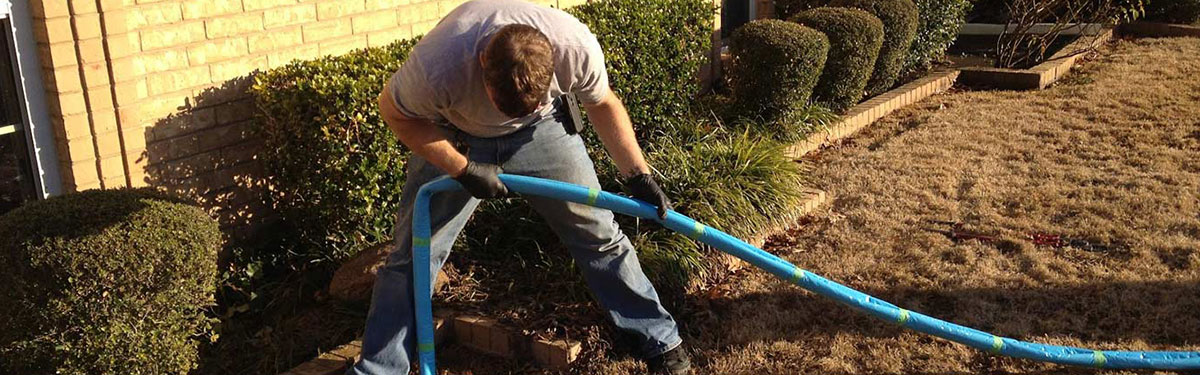 underground-plumbing-repair Underground plumbing specialist working on a water and sewer line repair